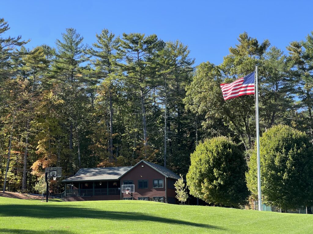 Flagpole on green lawn